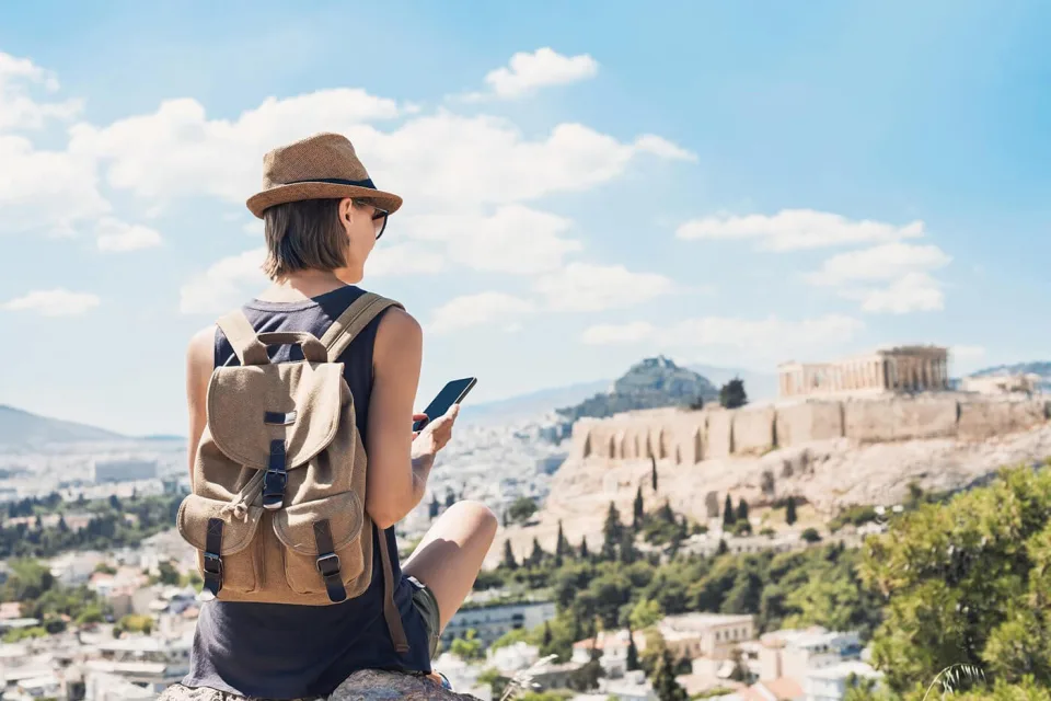 Traveller with a backpack overlooking a coastal city
