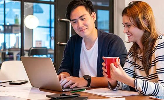 Two colleagues working together at a laptop